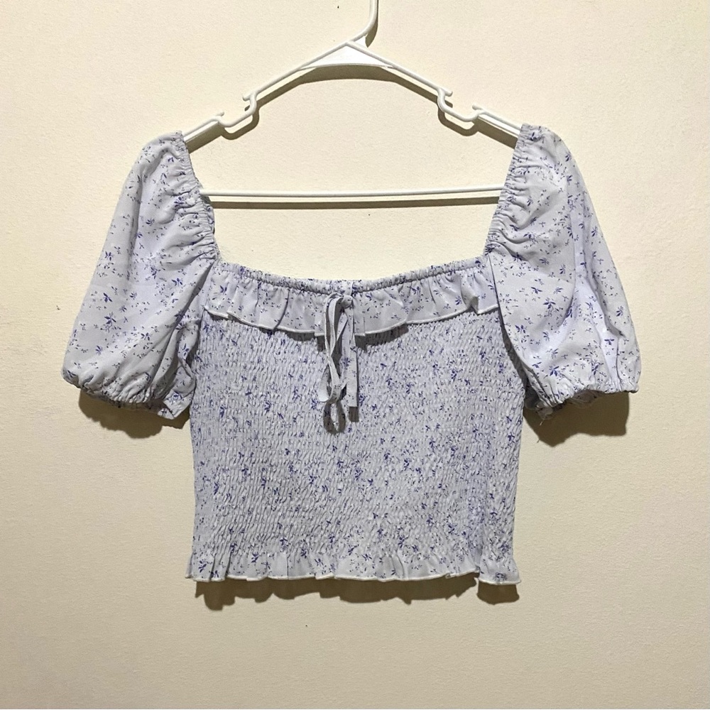 White top with purple floral design